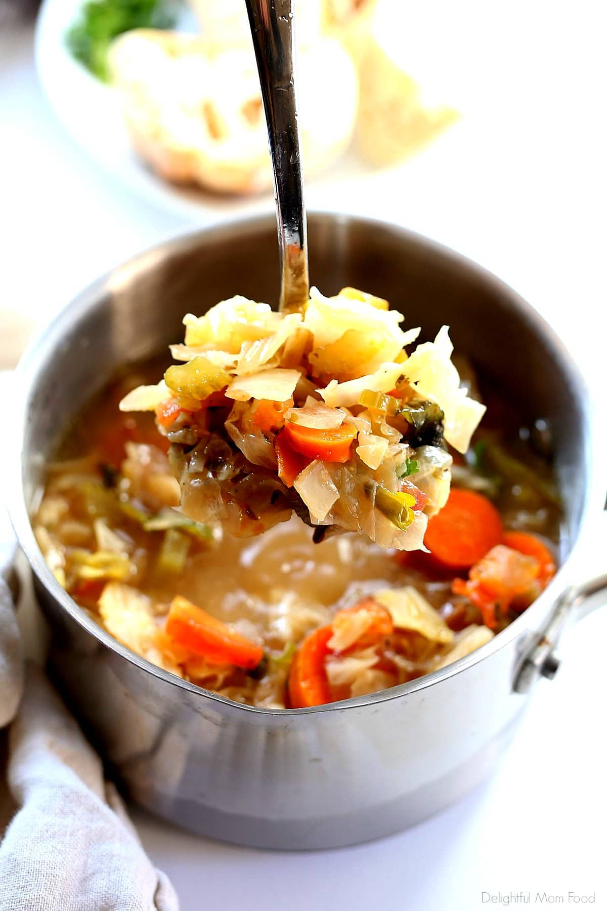 Spoonful of detox cabbage soup in miso broth to support weight loss