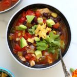 healthy chicken tortilla soup recipe in a bowl with a spoon