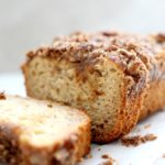 loaf of sliced gluten-free banana bread with a streusel topping