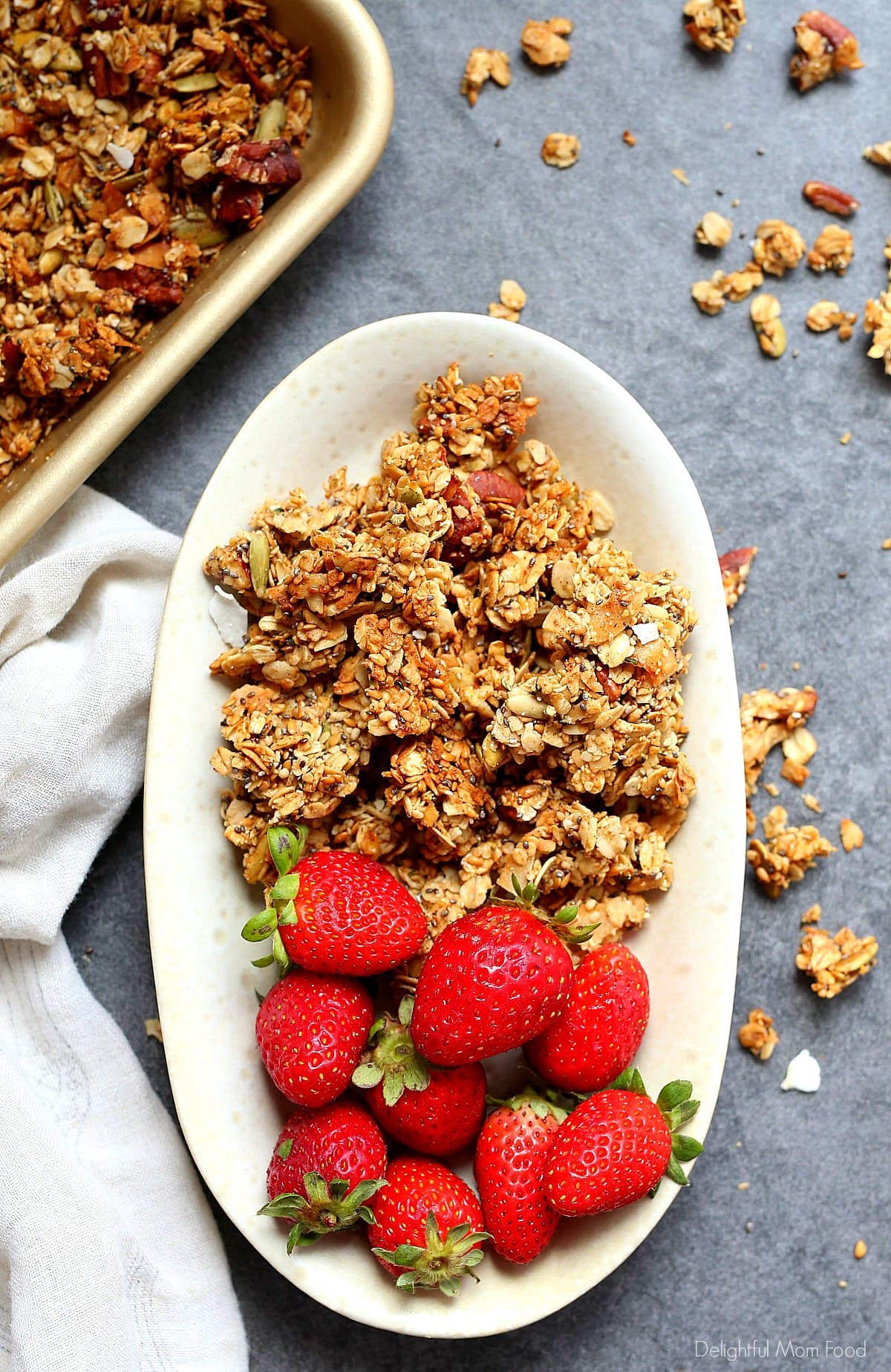 homemade granola on a dish with fresh strawberries