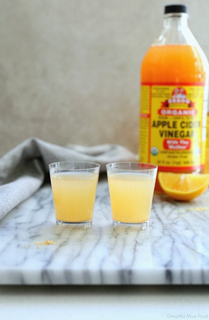 two apple cider vinegar shots in shot glasses