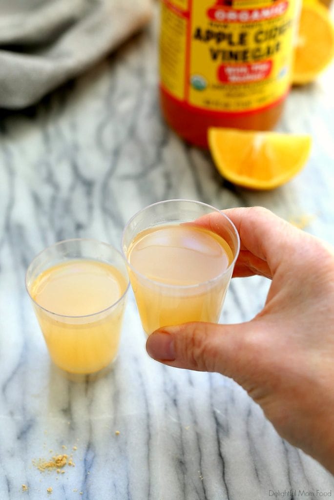 two acv shots with a hand holding one shot
