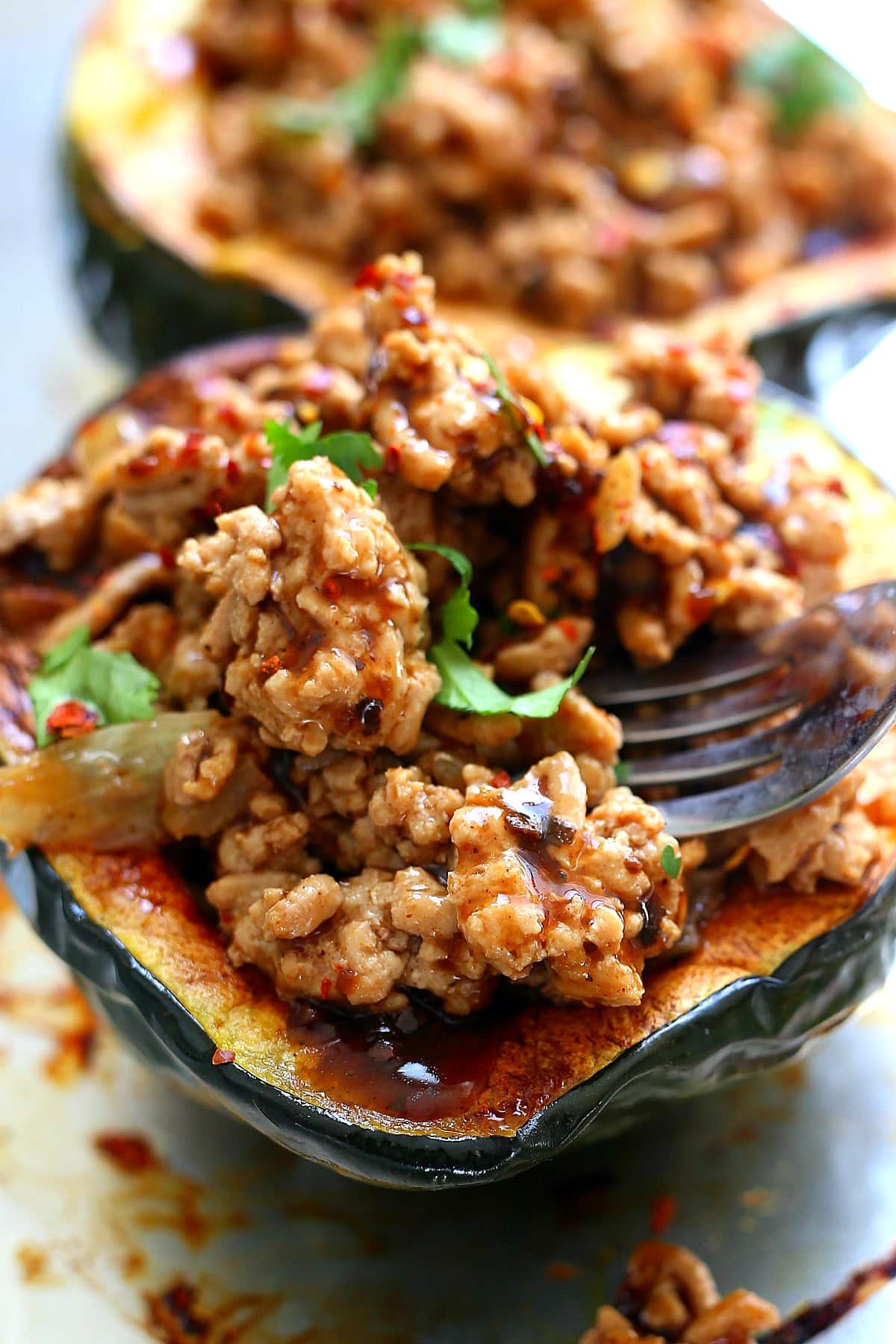 acorn stuffed squash filled with ground turkey meat in Korean BBQ sauce