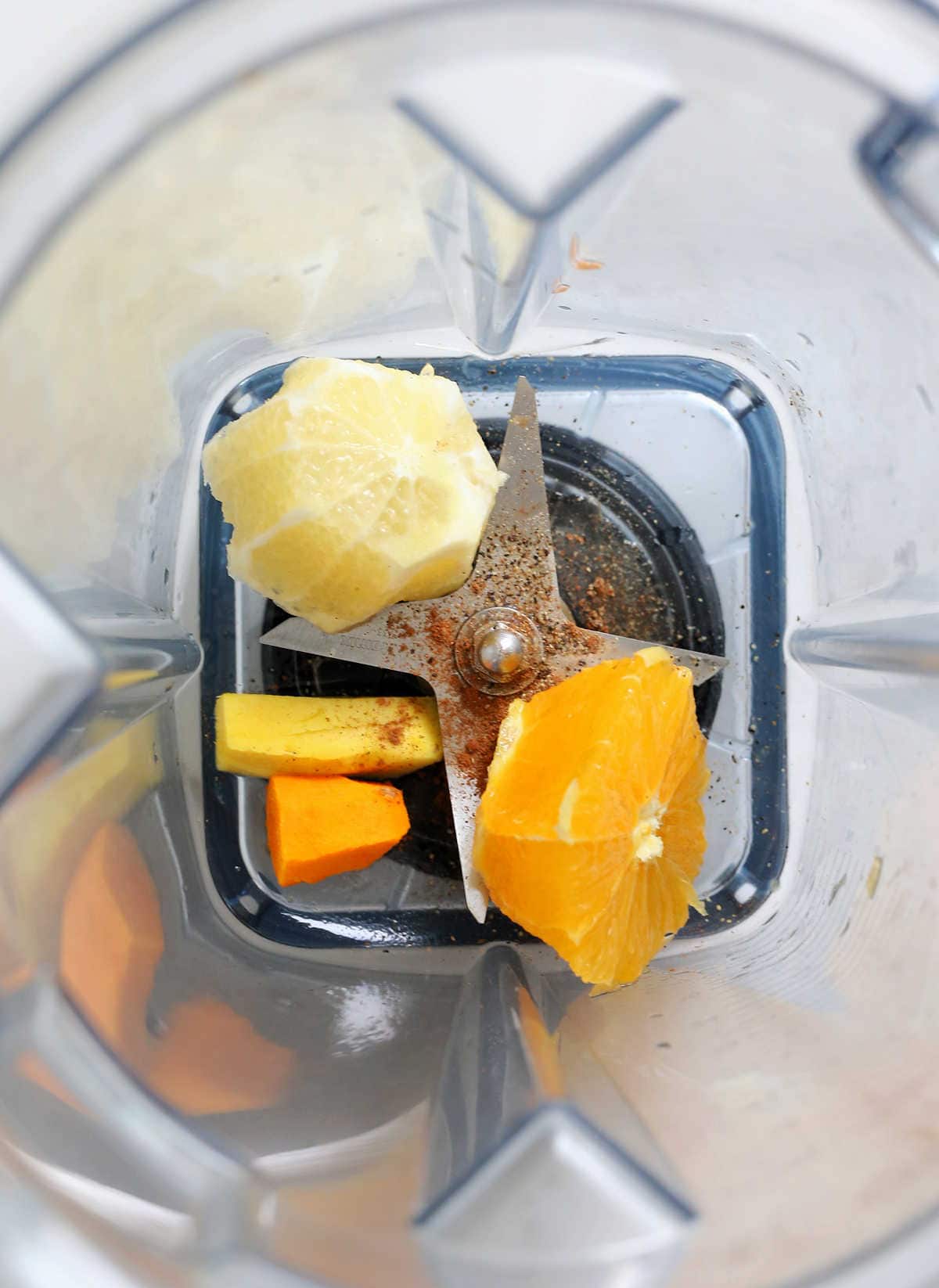 Ginger and turmeric shot ingredients in a vitamix blender.