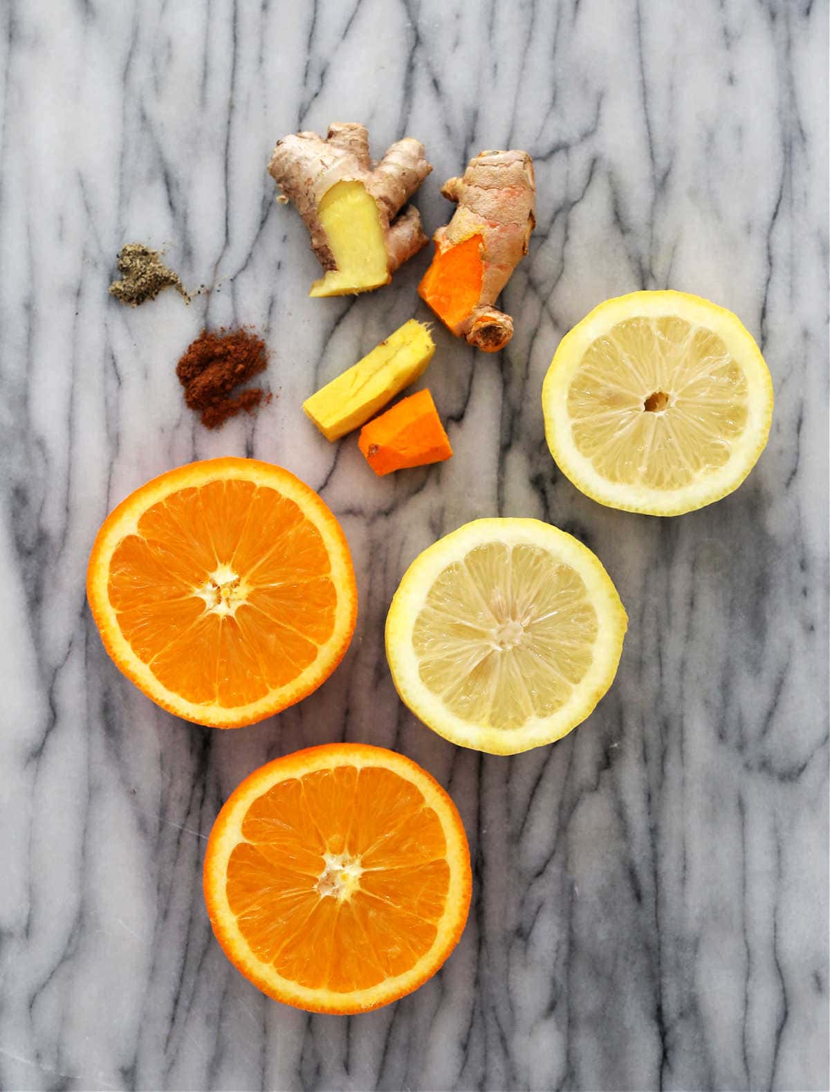 Ingredients of ginger root, turmeric root, orange, lemon, pepper, cayenne pepper.