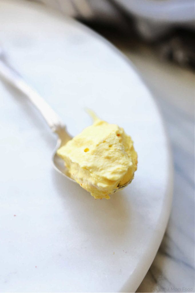 gourmet mustard deviled egg filling on a spoon