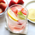 detoxing strawberry water for weight loss and clear skin infused with strawberries lemon and mint in a glass with ice