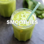 mango green smoothie in a glass with a straw
