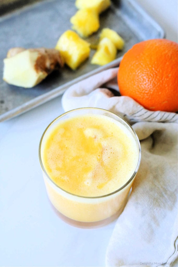 glass of juice made with pineapple and orange