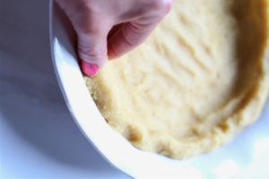 crimping a pie crust with hands