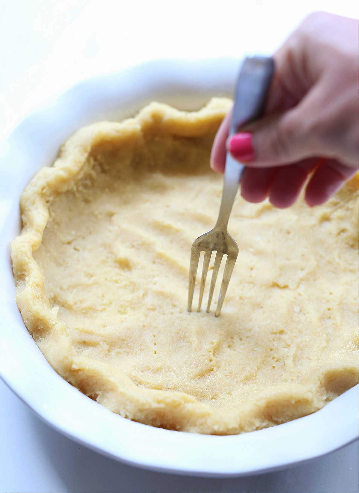 poking pie crust with a fork