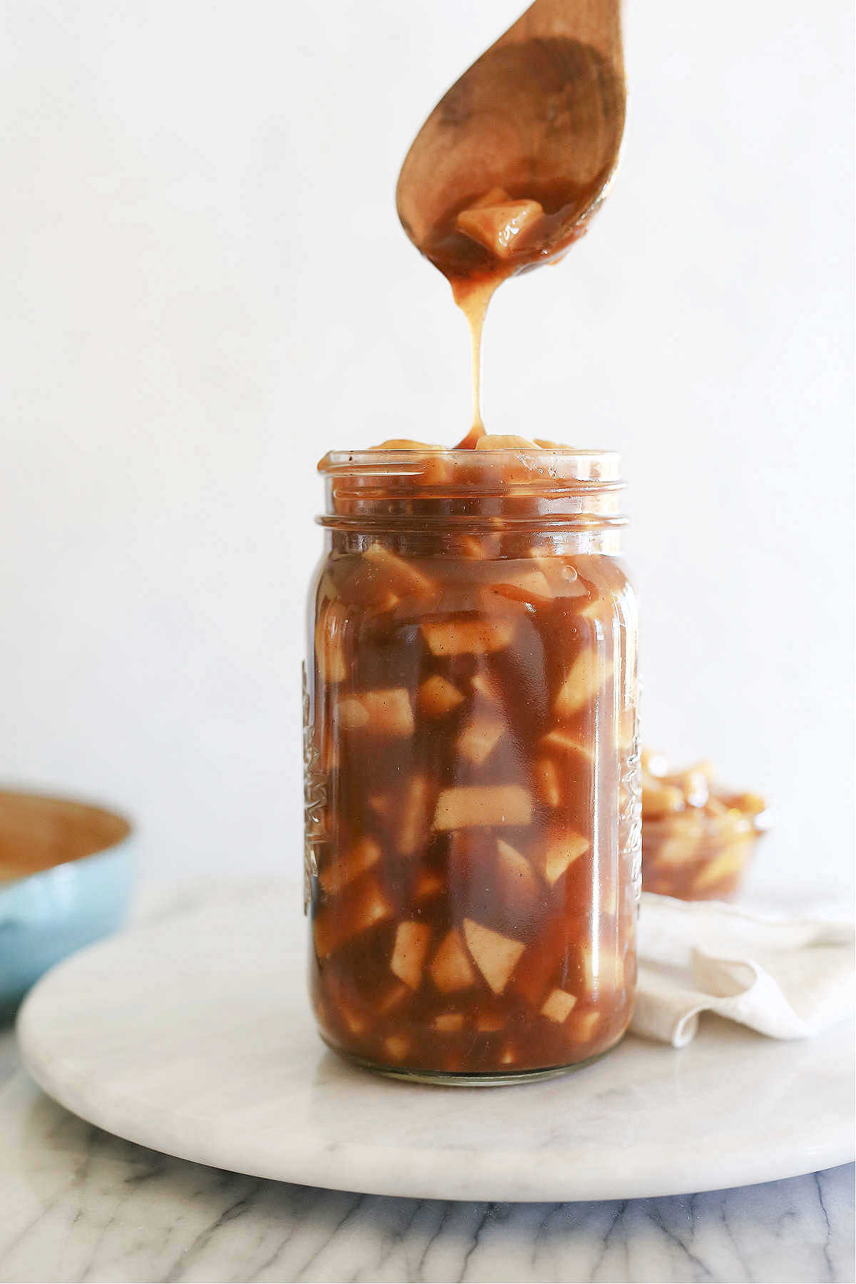apple pie filling in a mason jar with a serving spoon