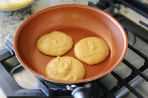 pumpkin pancake batter cooking on the stove top