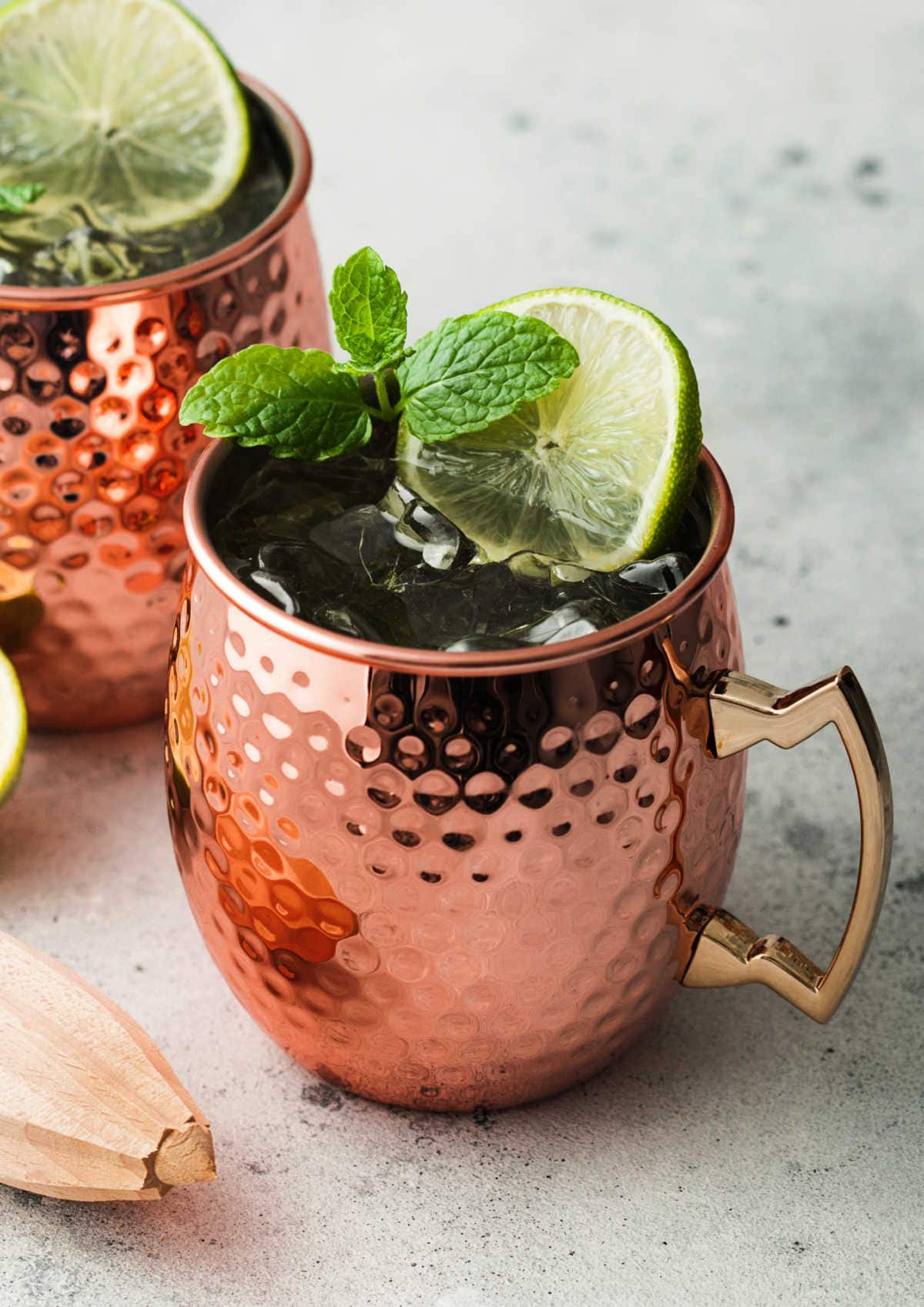 moscow mule in a copper mug with lime wedge and mint