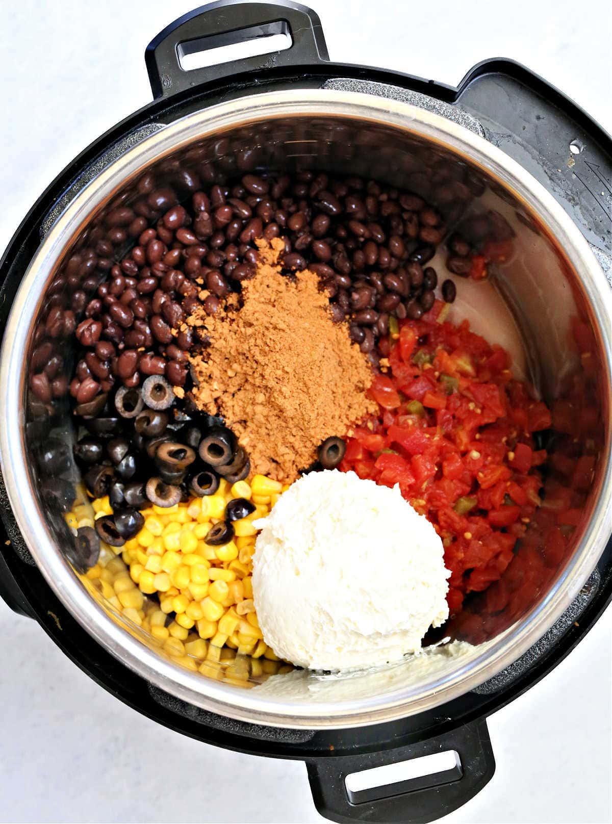 ingredients for a creamy chicken taco recipe in a crockpot
