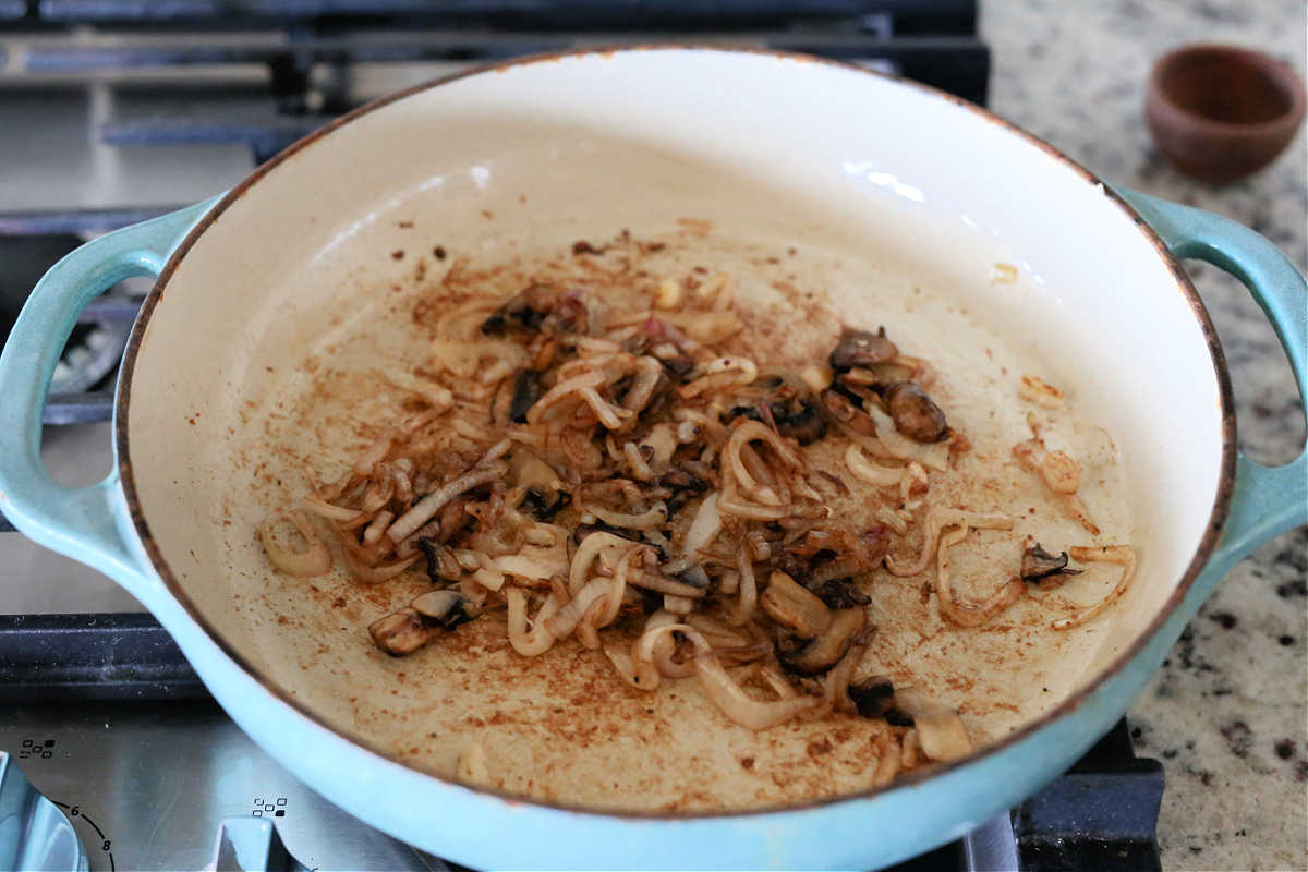 Caramelized onions shallots mushrooms in a saucepan. 