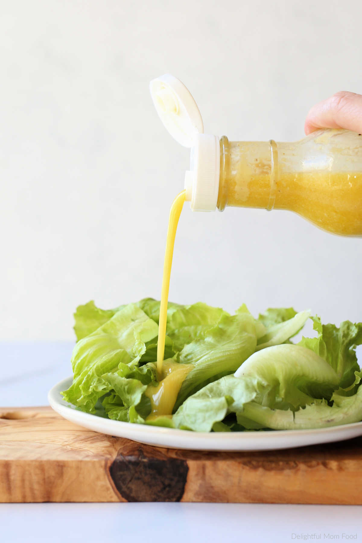 pouring dressing on a salad