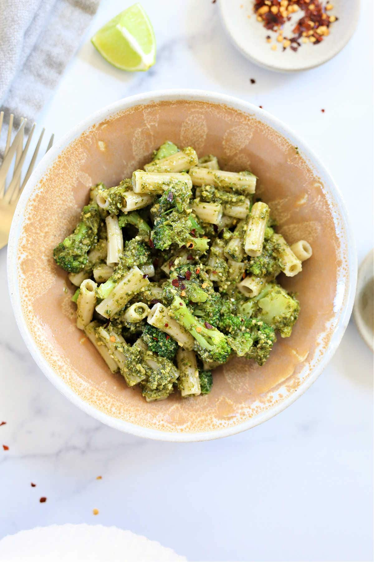 cilantro and basil pesto pasta with broccoli in a bowl