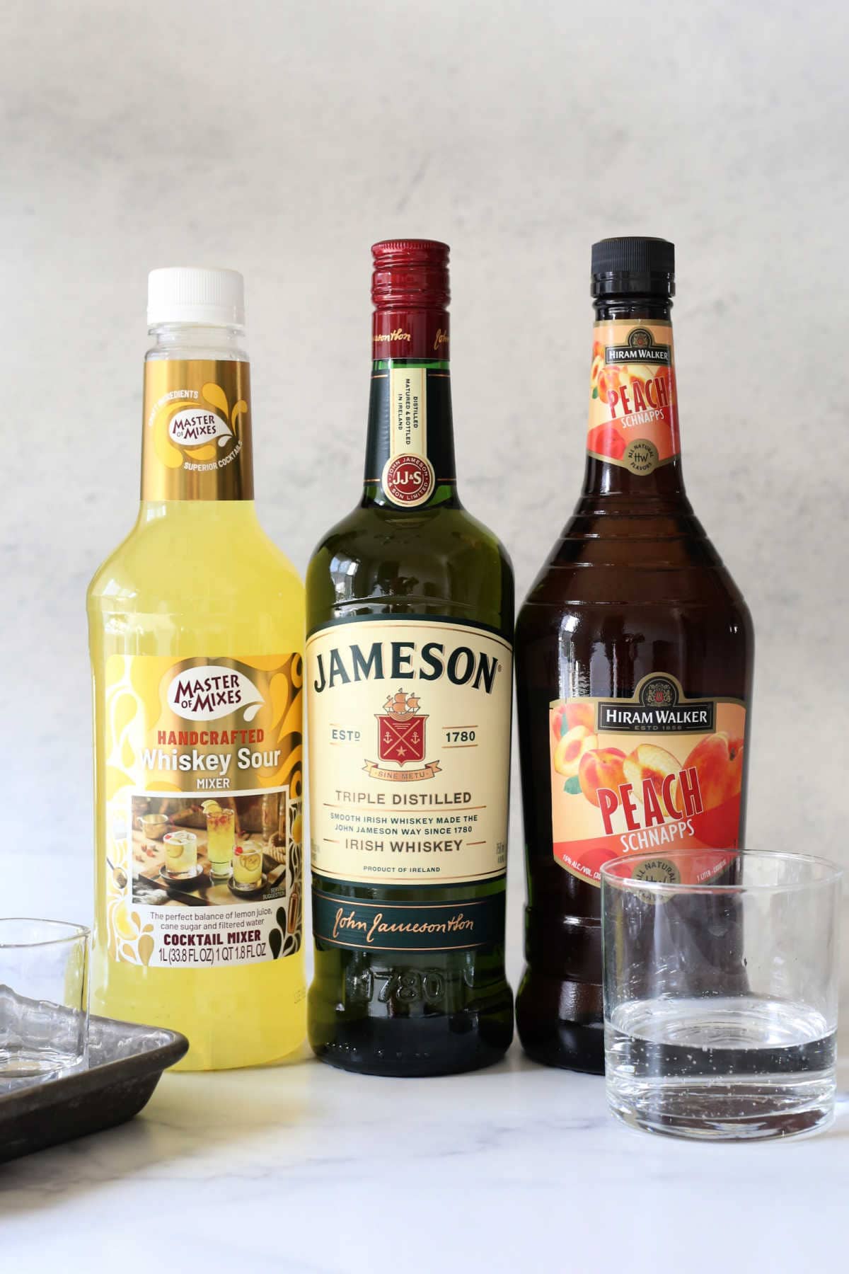 ingredients for green tea shots: irish whiskey, peach schnapps, whiskey sour mix, lemon lime soda