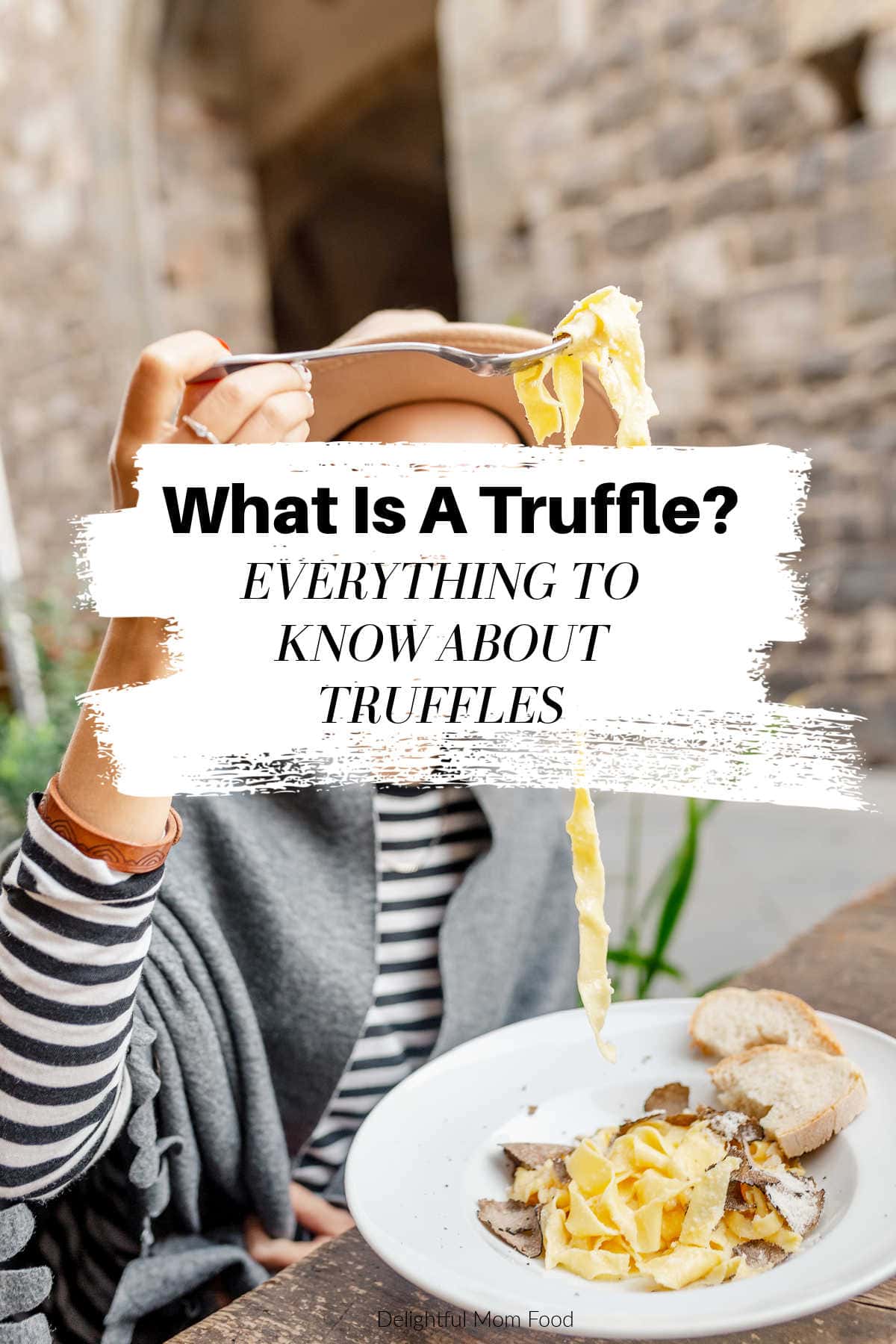 what is a truffle with black truffle over pasta and women eating it