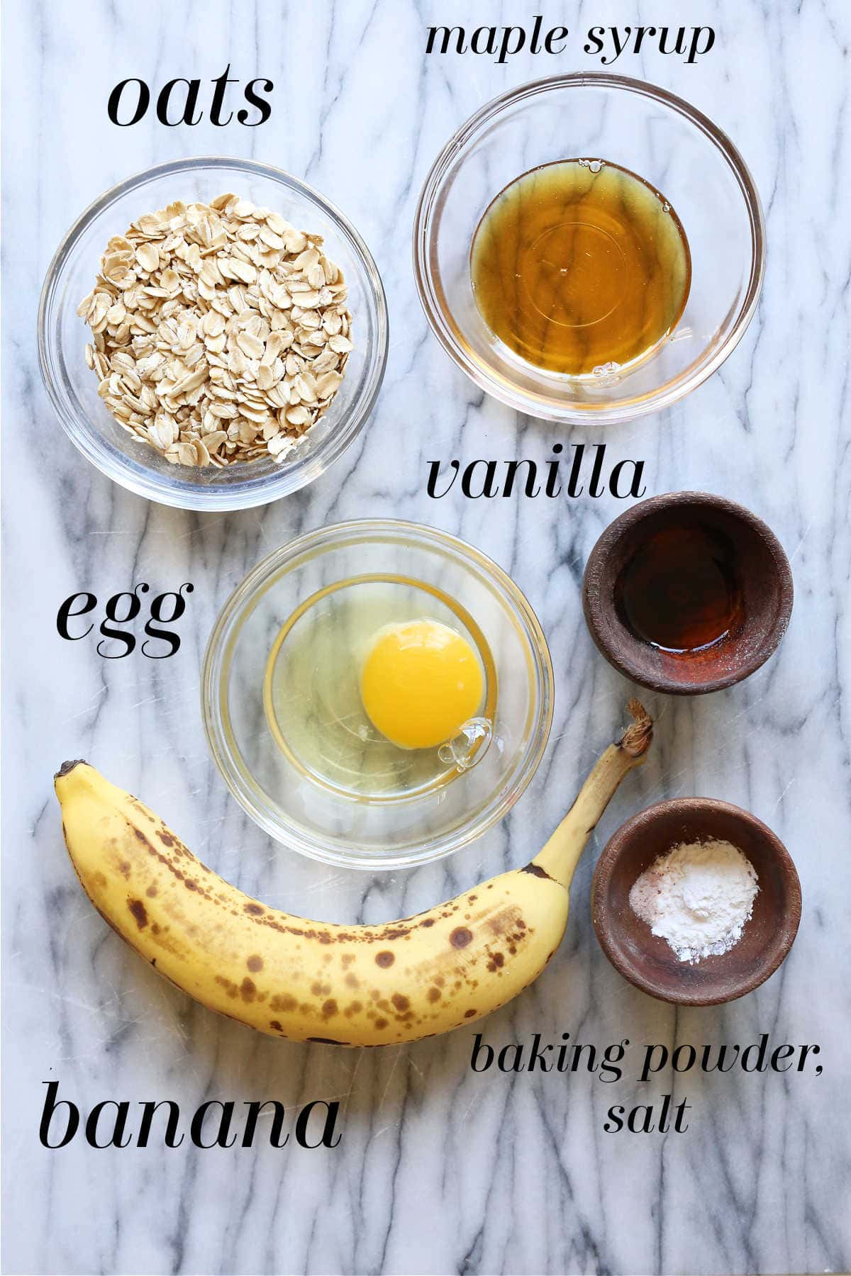 baked oats ingredients of old fashioned rolled oats, banana, egg, maple syrup, vanilla, baking powder, salt