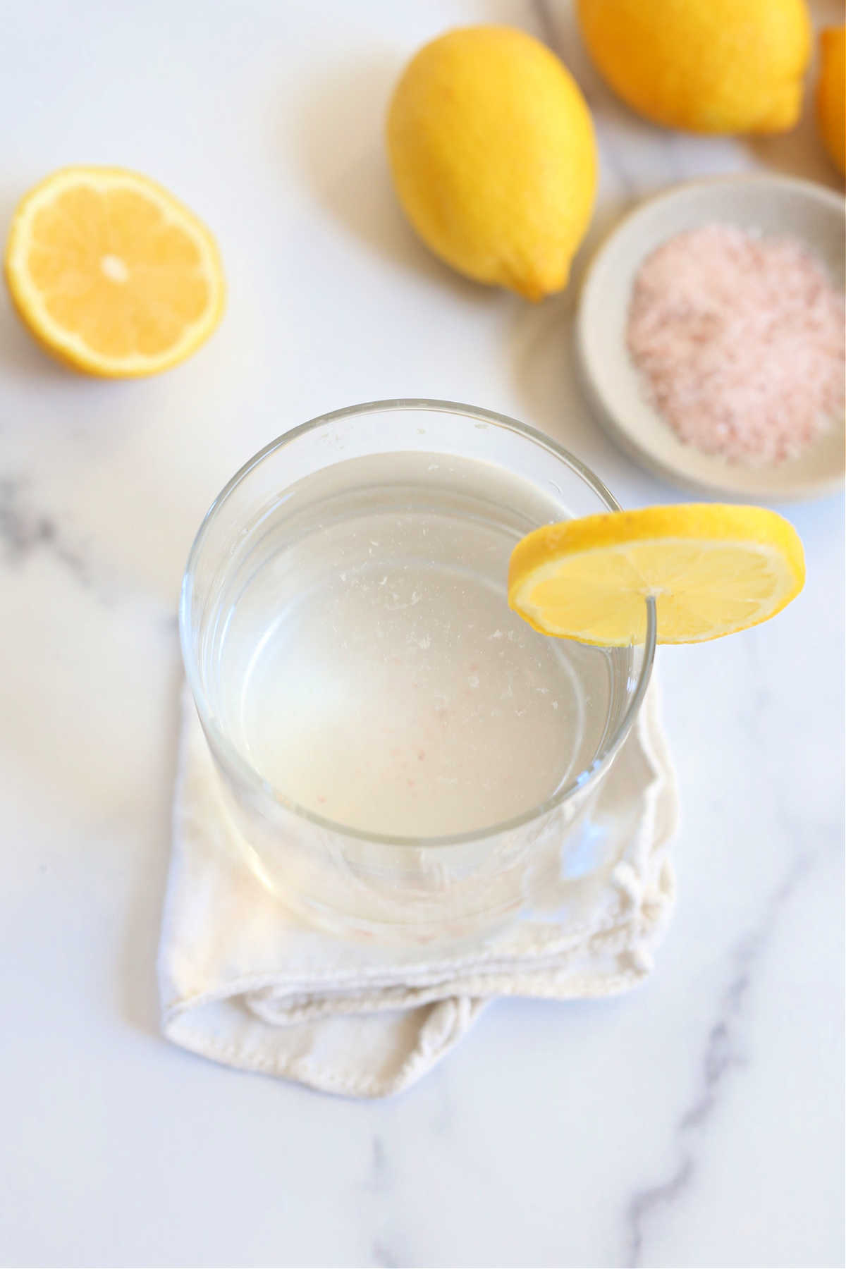 glass of lemon water with Himalayan pink salt