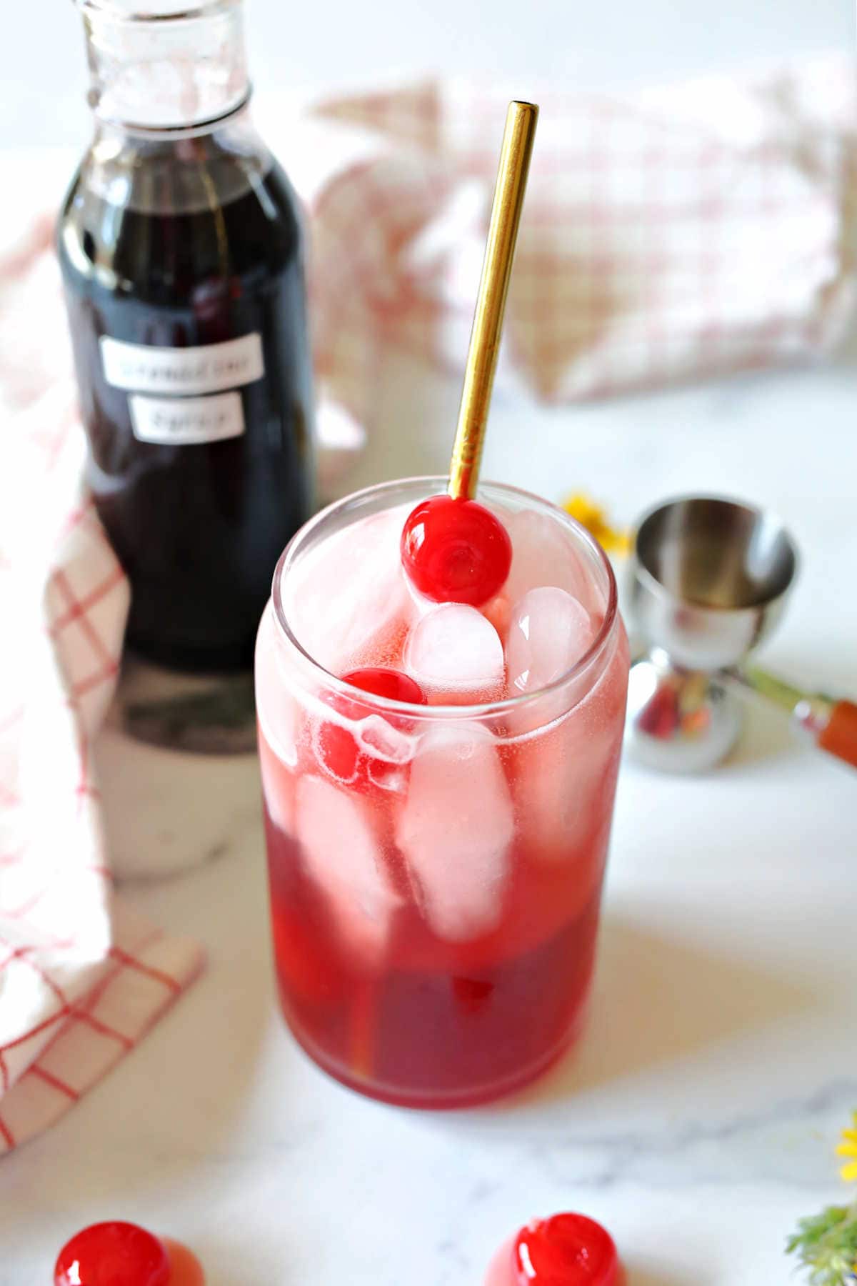 shirley temple drink with a cherry and straw