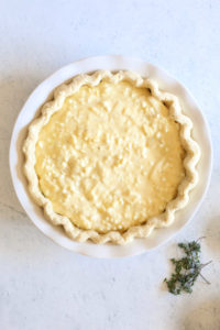 quiche filled with egg and cheese filling before baking