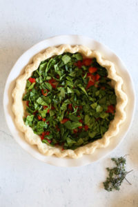 quiche filled with spinach and peppers