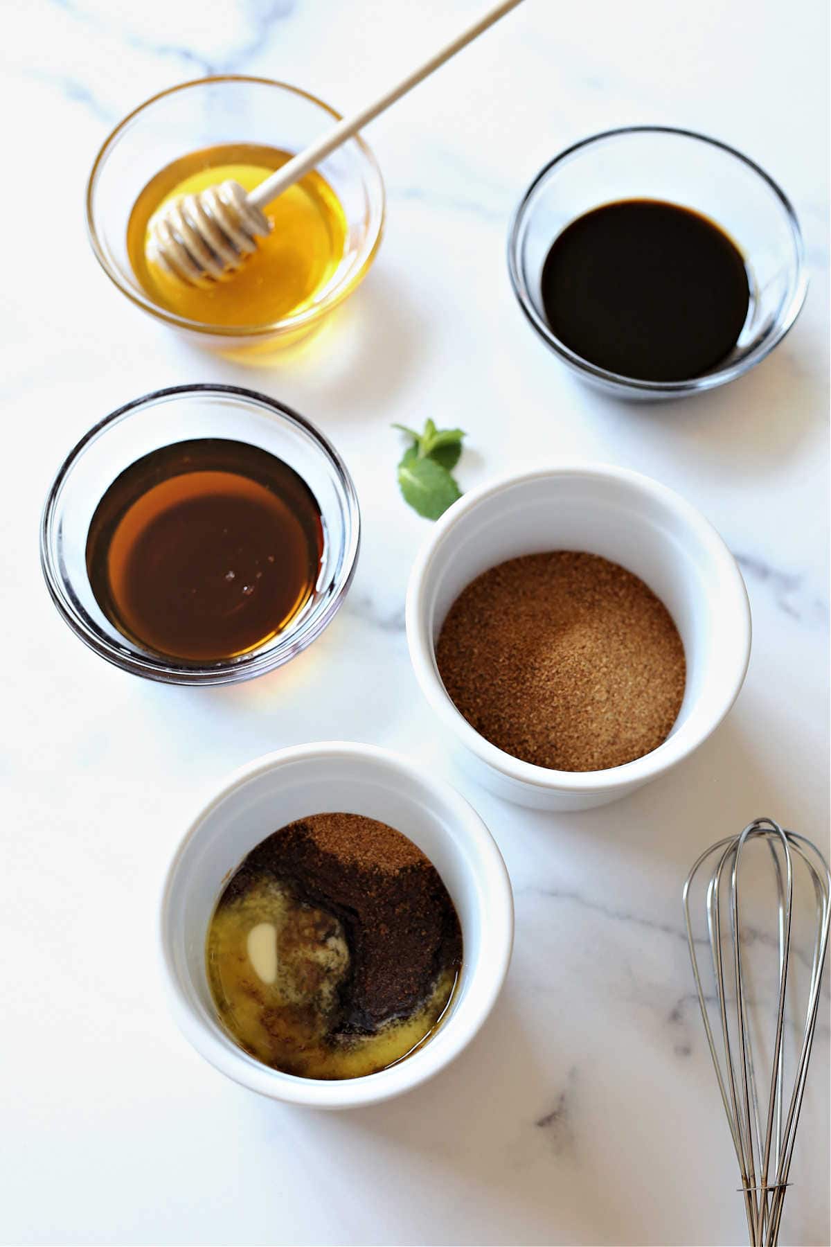 Maple syrup substitutes in a bowls with a whisk.