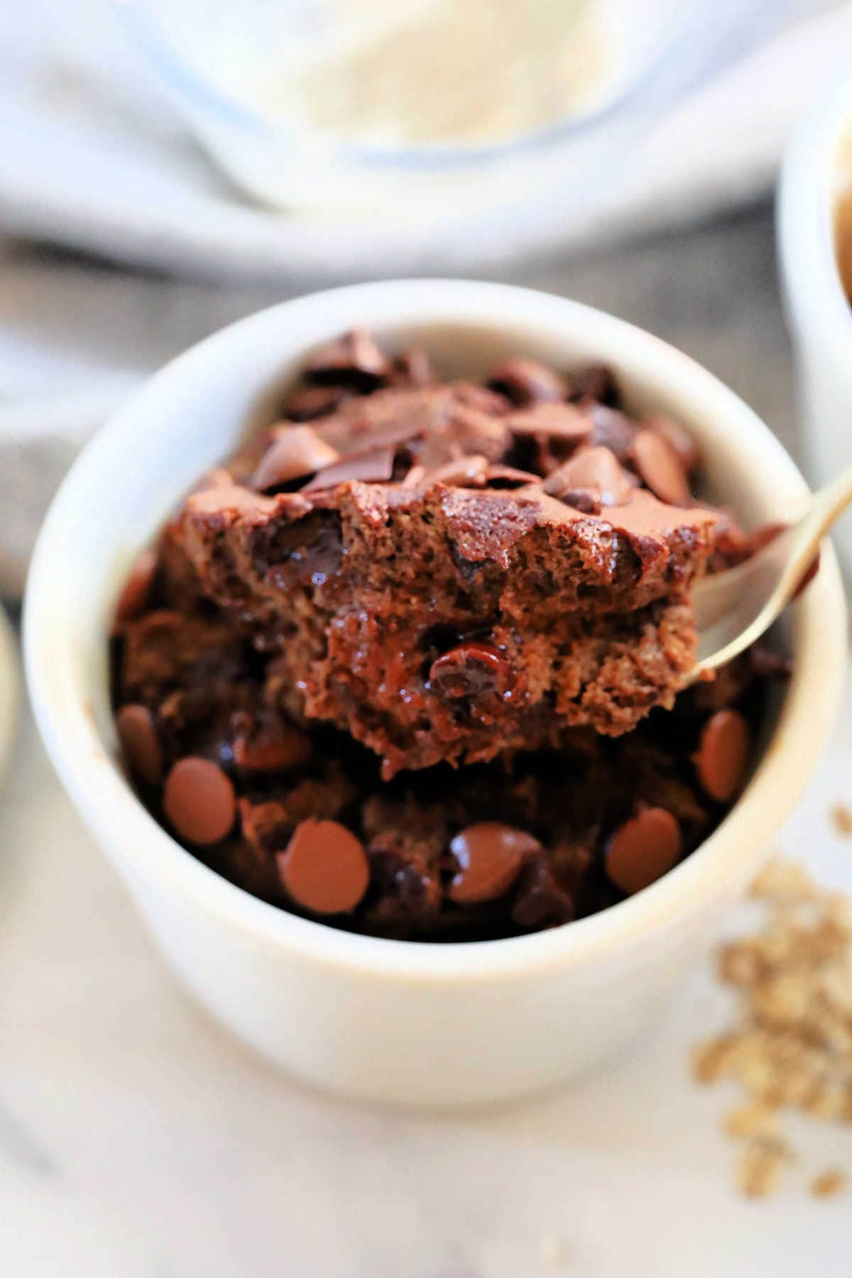 ramekin with health baked chocolate oats scooped with a spoon