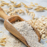 oat flour in a wooden scooping spoon