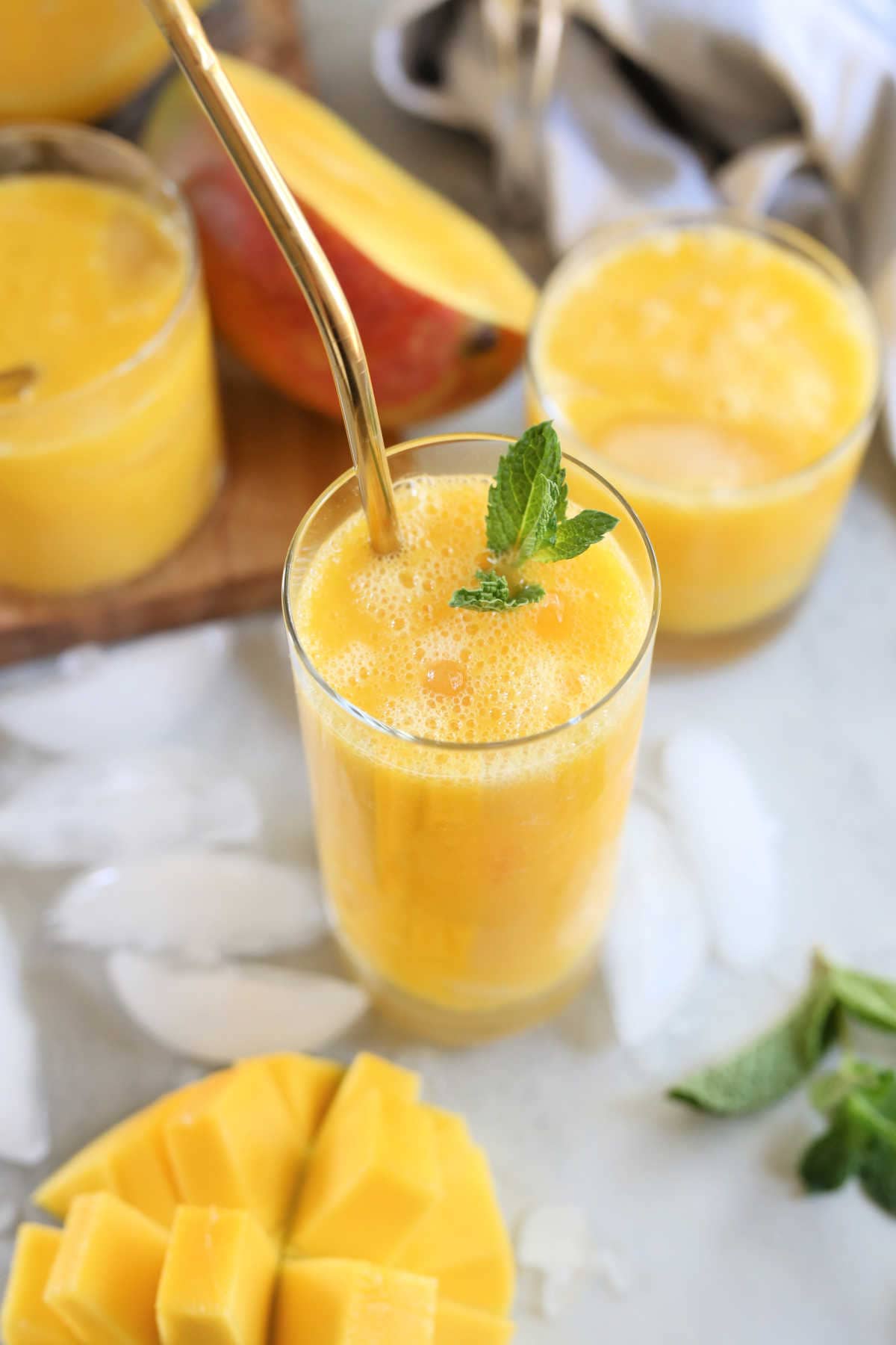 Mango nectar drink recipe in a glass with gold straw