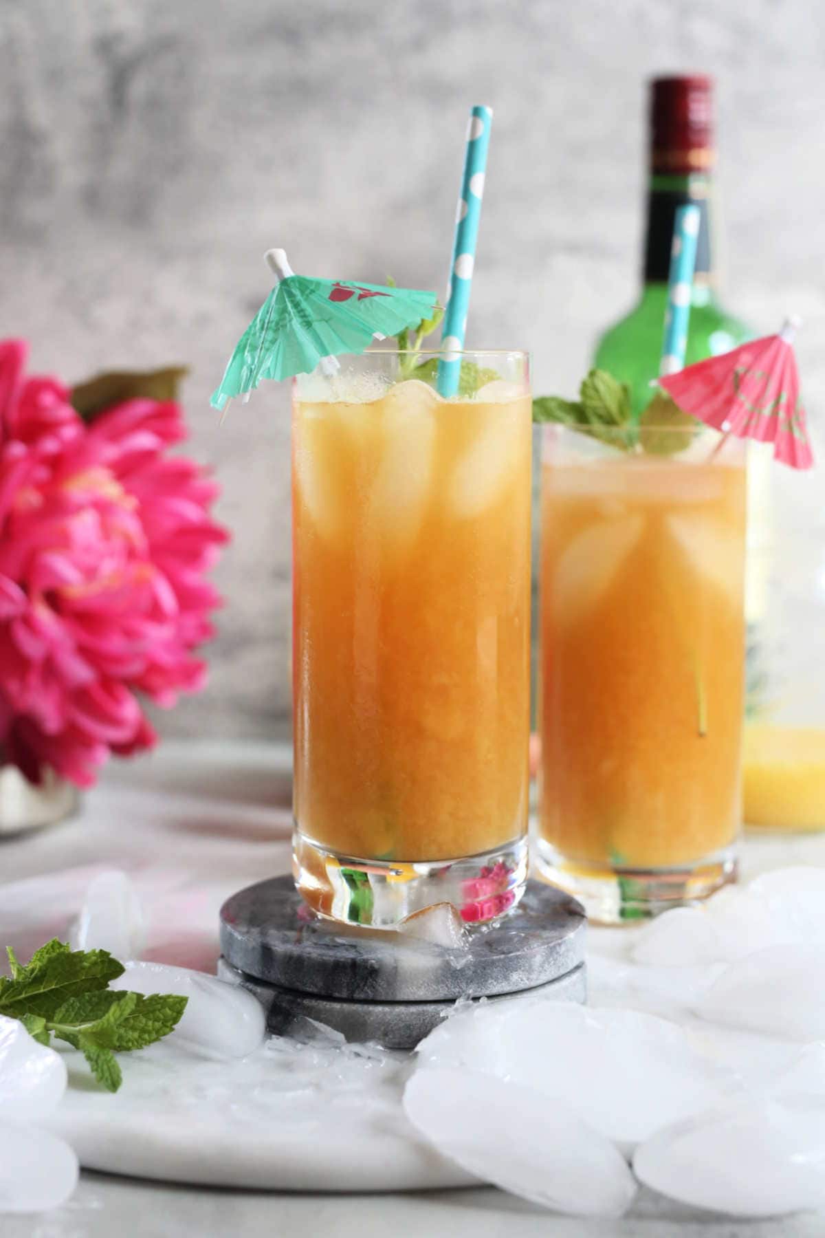 earl grey cocktail recipe in two glasses made with fresh mango juice
