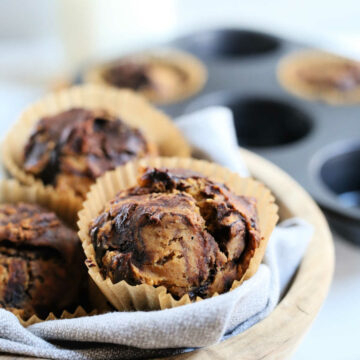 batch of homemade nutella muffin in a wooden bowl on a grey dish towel