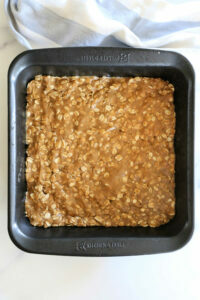 pressed strawberry crumble batter in a baking pan