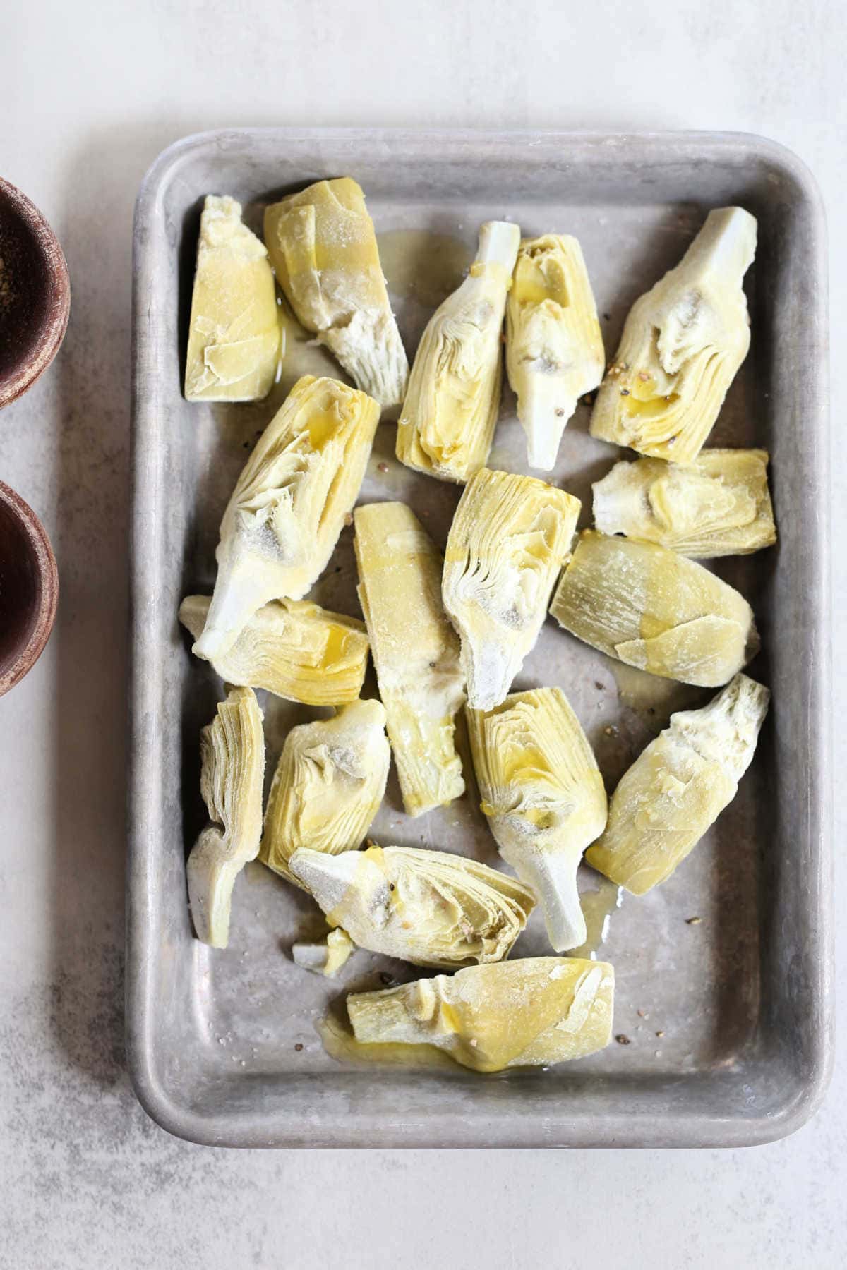 frozen artichoke hearts on a baking pan
