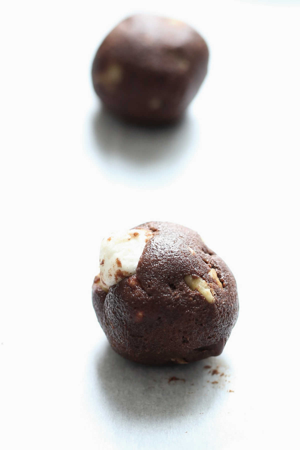 ball of chocolate rocky road cookie dough on parchment paper