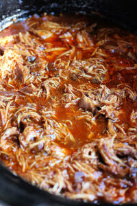 shredded pulled BBQ chicken in a crock pot slow cooker