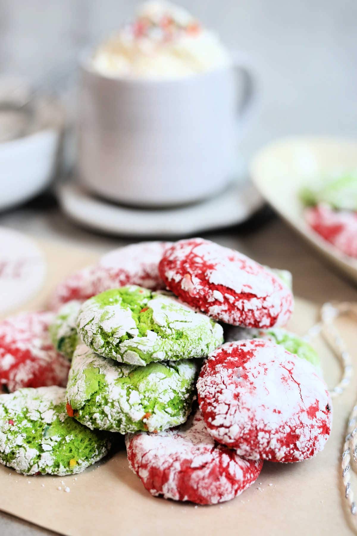 stack of red and green holiday crinkle cookies on parchment paper