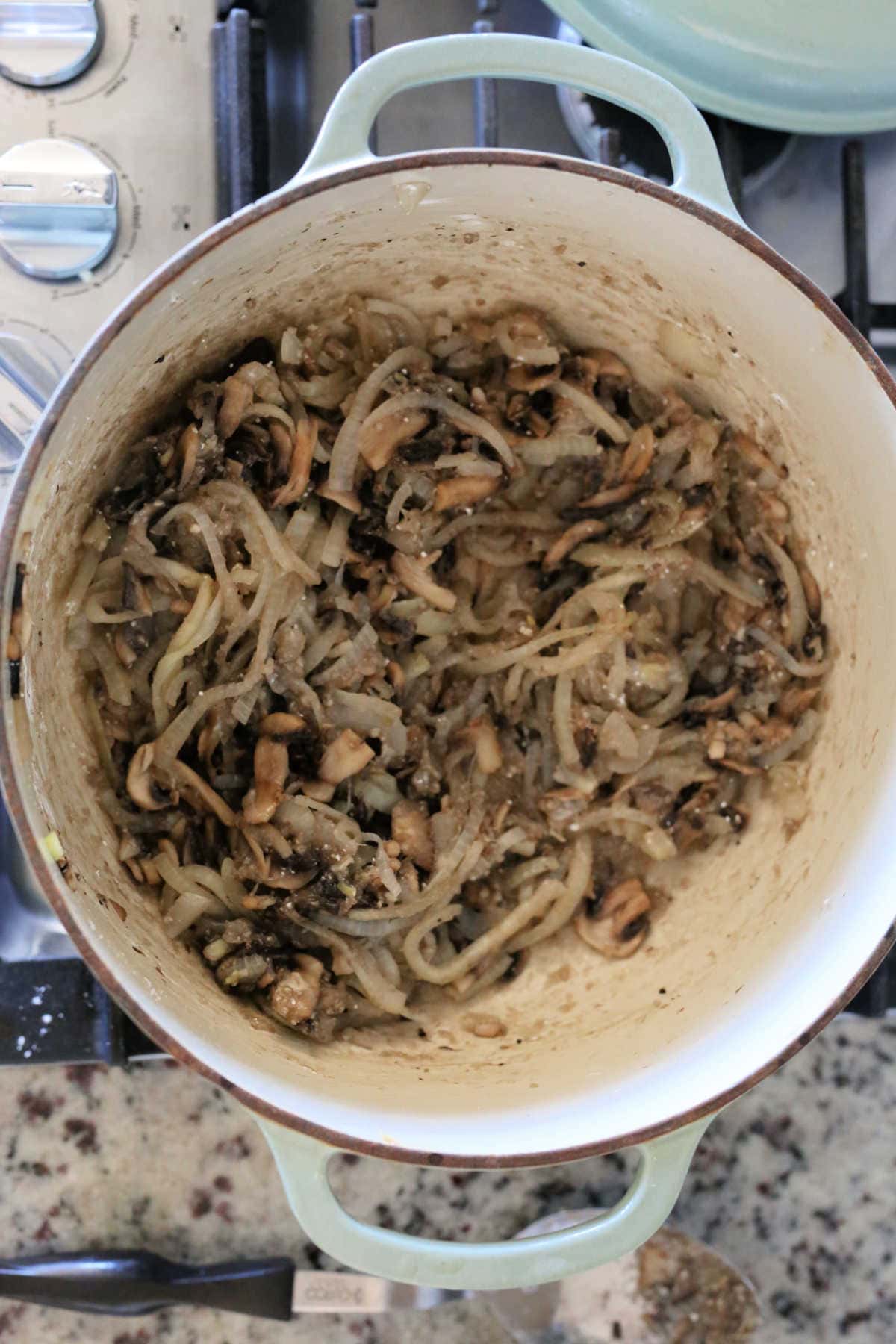 mushroom and onion slices cooked in a pot with cornstarch to make a roux