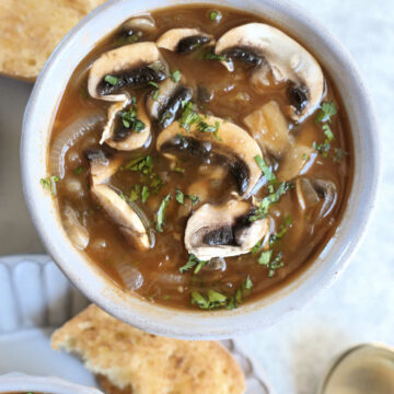 mushroom onion soup in a bowl with crispy bread
