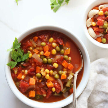easy vegetarian soup made of frozen vegetables in a bowl with a spoon