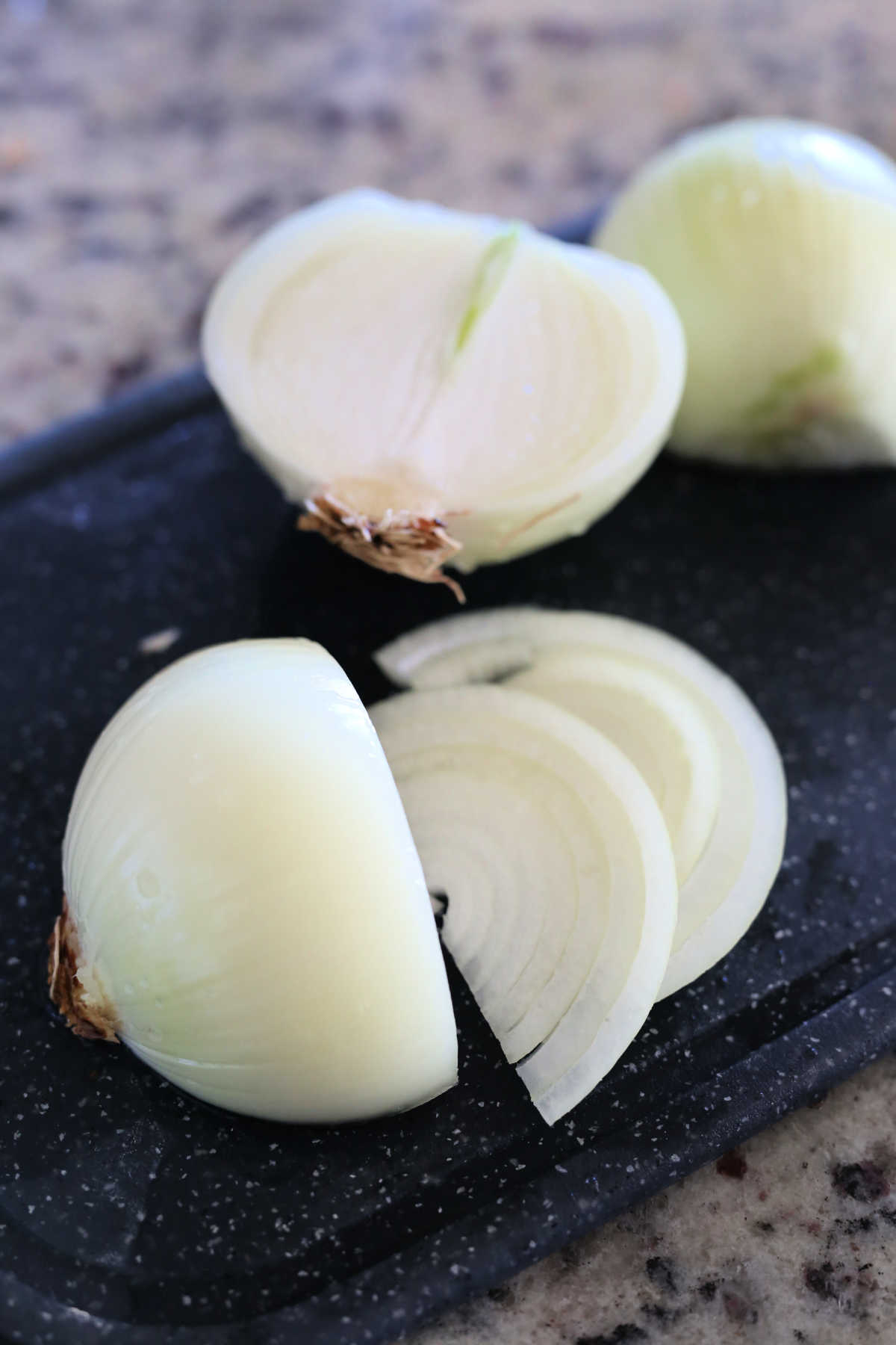 onion cut into slices on a cutting board