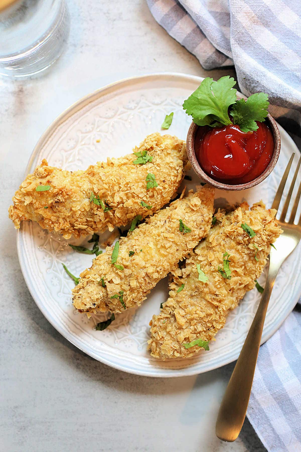 Easy Air Fryer Chicken Tenders on a Plate with a Gold Fork