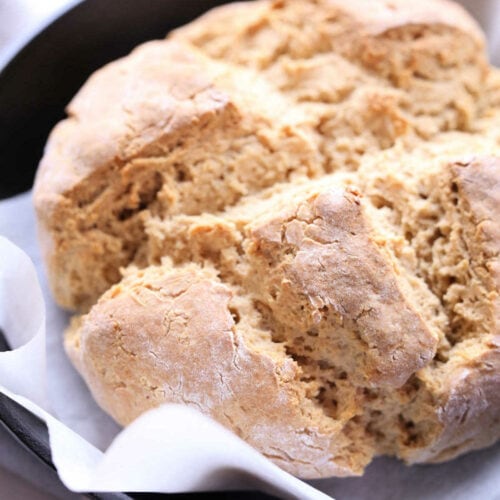close up of Irish soda bread loaf on parchment paper