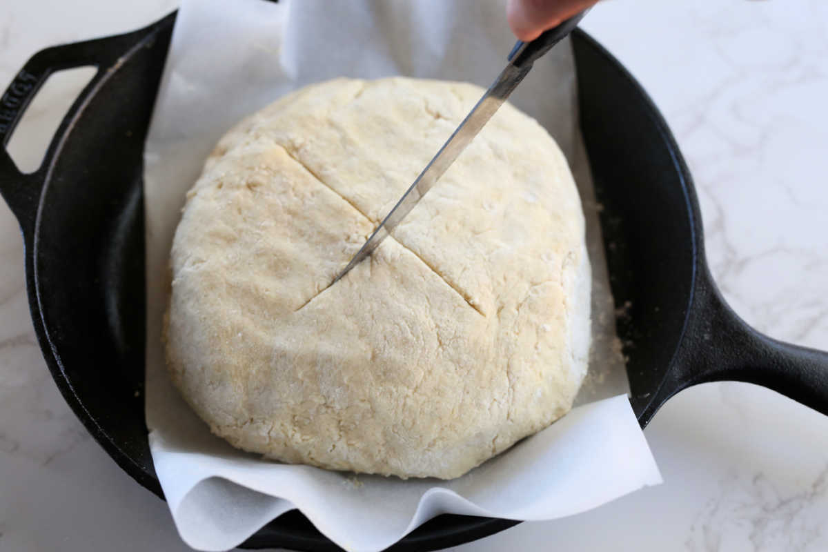 Knife Making "X" Shape In Irish Soda Bread Dough