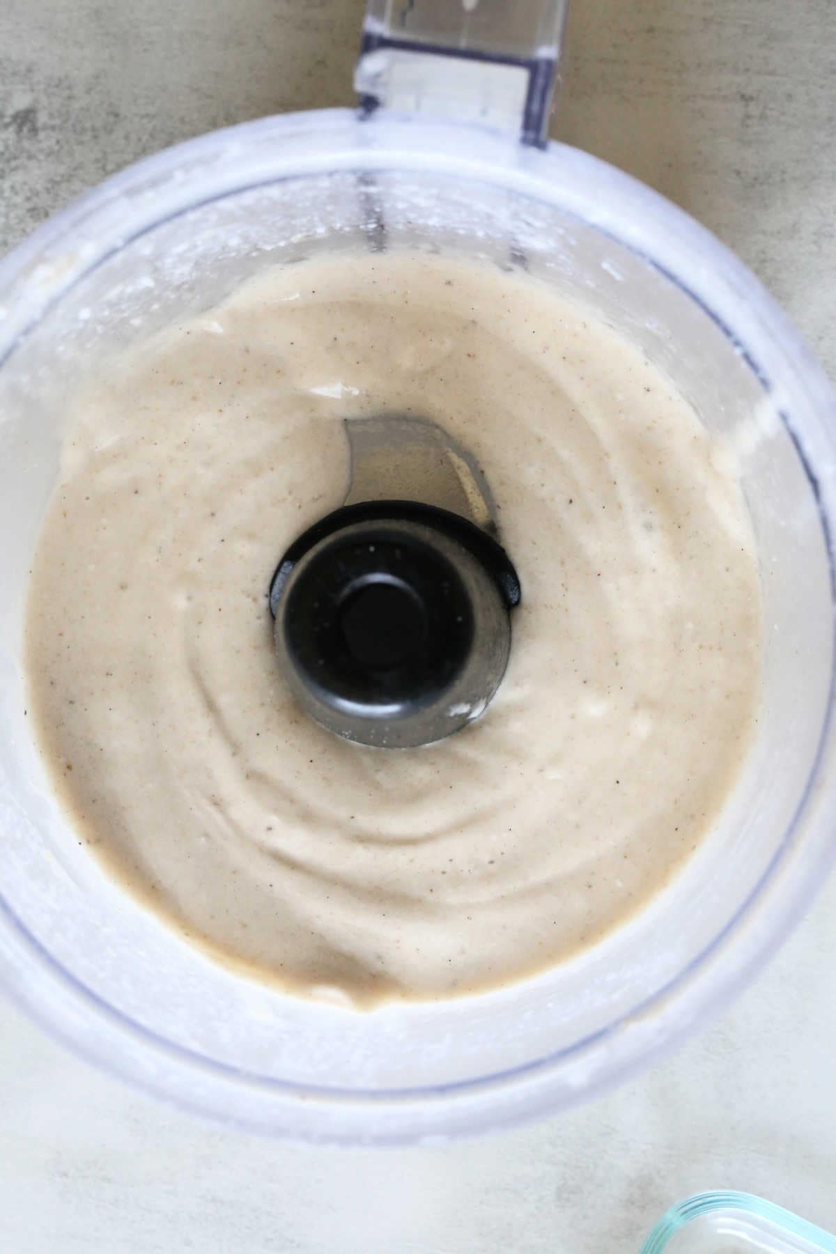 Pureed Frozen Bananas and Coconut Milk in a Food Processor for Ice Cream