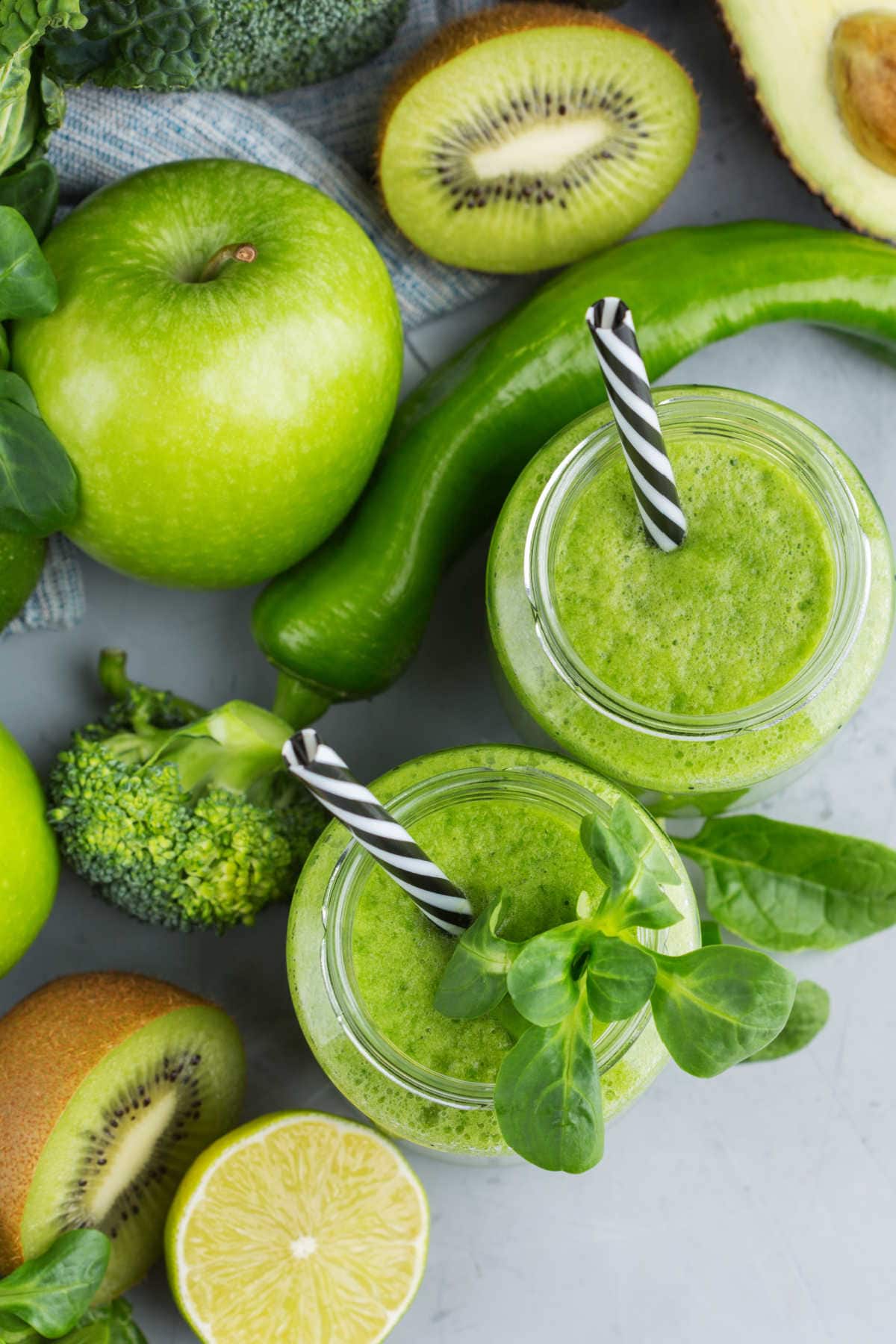 Green Fruits on a Counter Including Kiwi Lime Avocado