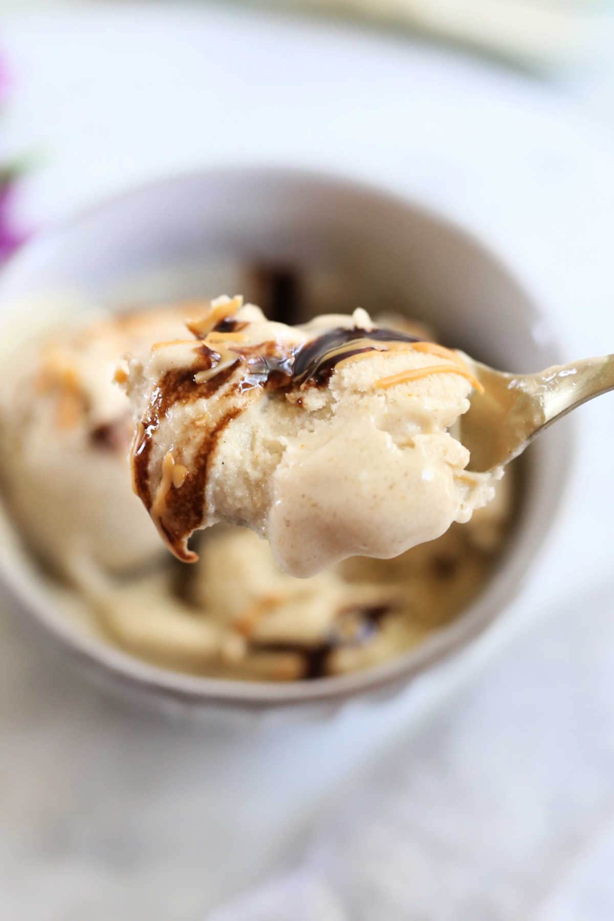 Spoon of Vegan Ice Cream Made with Bananas and Topped with Chocolate and Peanut Butter